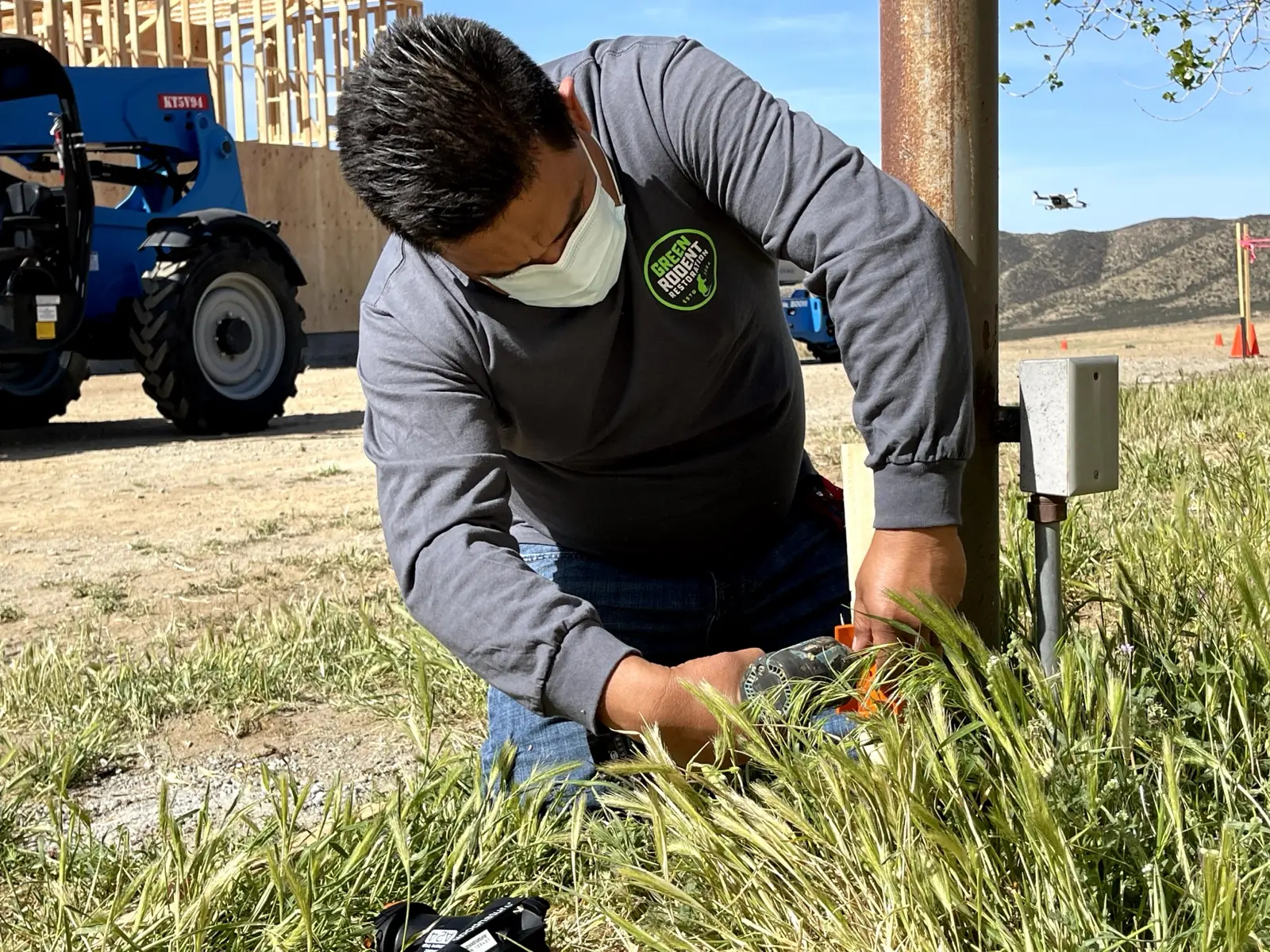 Technician working at the base of a home during a wildlife inspection